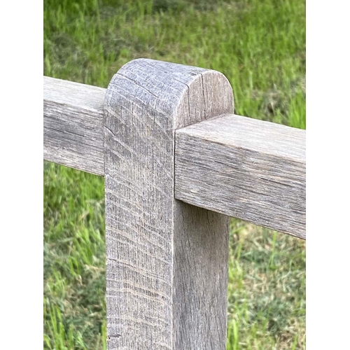 177 - GARDEN BENCH, weathered teak slatted with finely turned and stretchered front supports, 125cm W.