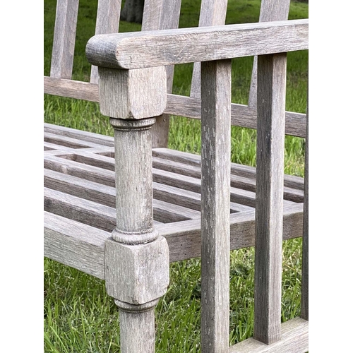 177 - GARDEN BENCH, weathered teak slatted with finely turned and stretchered front supports, 125cm W.