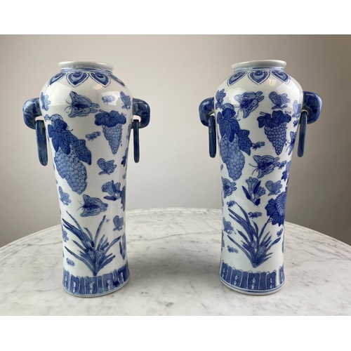 26 - CHINESE VASES, a pair, blue and white having butterflies, grapes and foliate decoration with elephan... 