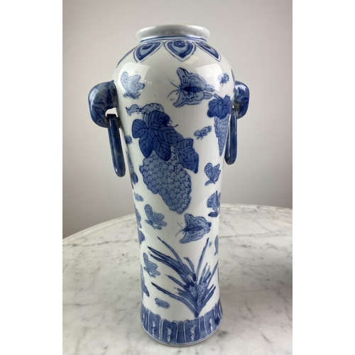 26 - CHINESE VASES, a pair, blue and white having butterflies, grapes and foliate decoration with elephan... 