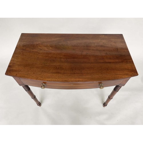 264 - WRITING TABLE, George III bowfronted mahogany with a full width frieze drawer and ring turned taperi... 