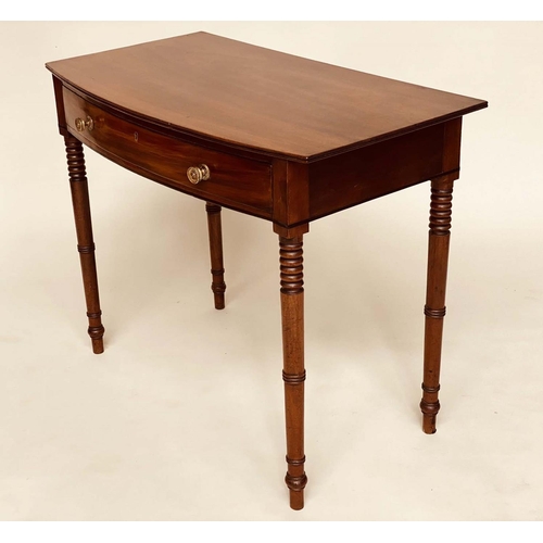 264 - WRITING TABLE, George III bowfronted mahogany with a full width frieze drawer and ring turned taperi... 