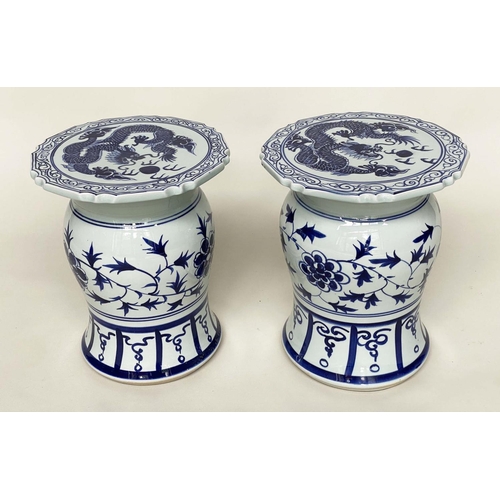 272 - CHINESE STOOLS, a pair, blue and white ceramic with dragon and leaf decoration, 40cm H x 33cm W. (2)