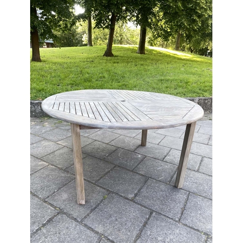 355 - GARDEN TABLE AND ARMCHAIRS, weathered, eight stacking armchairs included 64cm W, table 130cm W. (9)