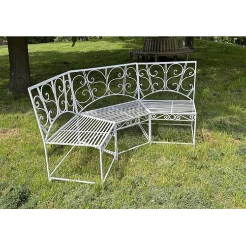 173 - GARDEN BENCH, white painted wrought iron corner or bowed with scroll back and rail seat (in three se... 