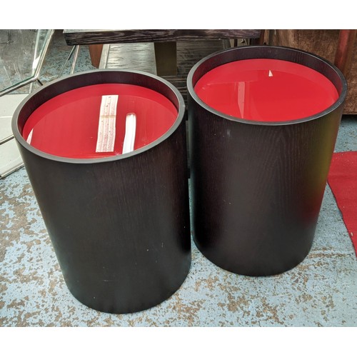 515 - SIDE TABLES, a pair, 40cm diam x 56cm H, dark wood, red glass tops on castors. (2)