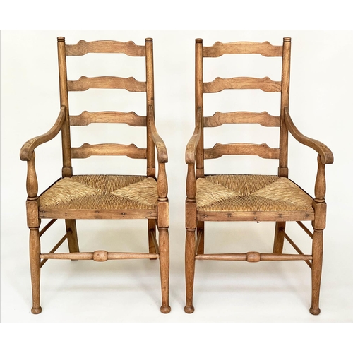 165 - ARMCHAIRS, a pair, early 20th century English oak with ladder backs and rush seats, 55cm W. (2)