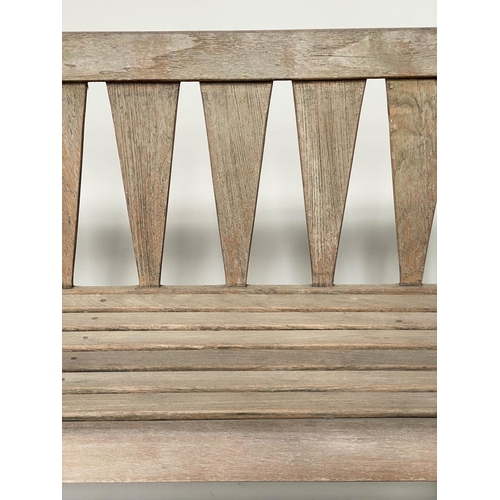 167 - GARDEN BENCH, weathered teak of slatted construction with triangular splat back, 140cm W.