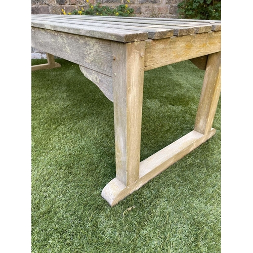 116 - LOW TABLE, rectangular weathered teak and slatted with stretchered supports, 149cm x 43cm x 42cm H.