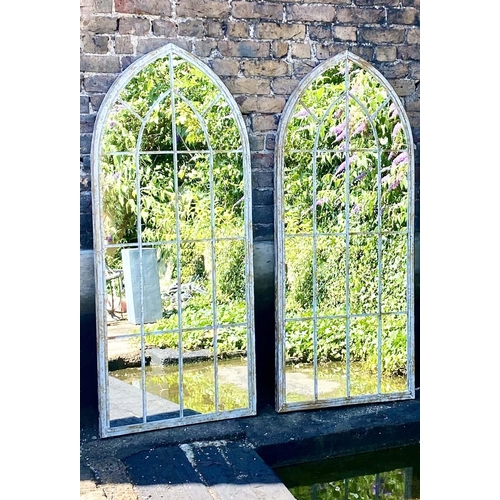 410 - ARCHITECTURAL GARDEN MIRRORS, a pair, 160cm high, 67cm wide, arched aged metal frames. (2)