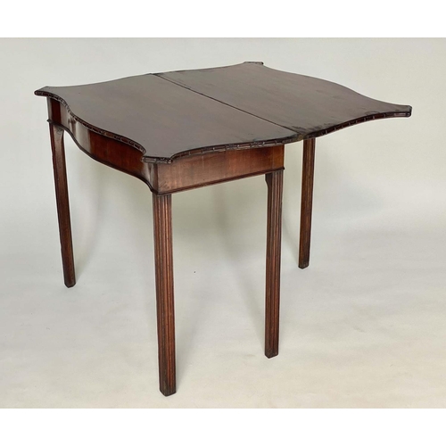 91 - TEA TABLE, George III figured mahogany of serpentine outline, foldover, with channeled square suppor... 