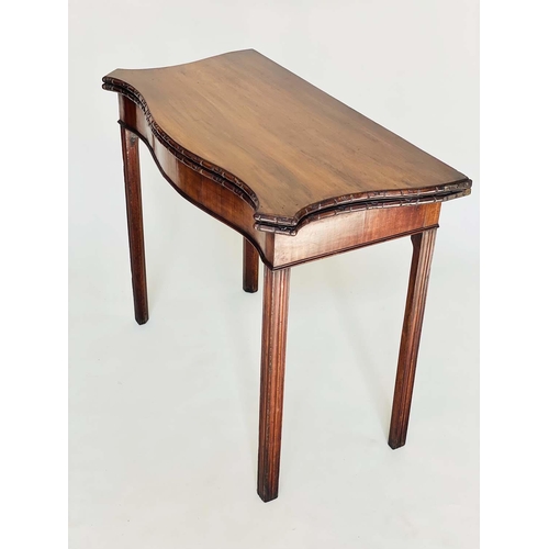 91 - TEA TABLE, George III figured mahogany of serpentine outline, foldover, with channeled square suppor... 