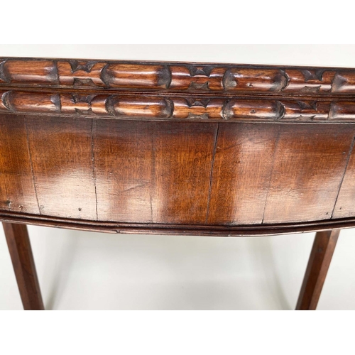 91 - TEA TABLE, George III figured mahogany of serpentine outline, foldover, with channeled square suppor... 