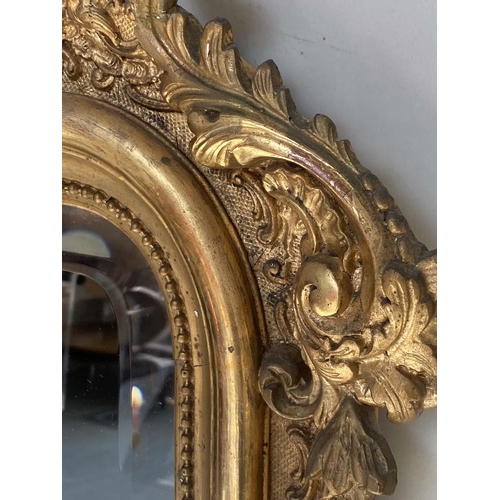 94 - OVERMANTEL MIRROR, 19th century French giltwood and gesso moulded with arched C scroll crest, beaded... 