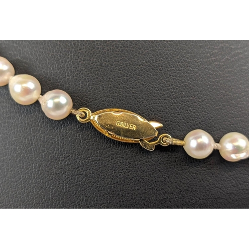 7 - THREE PEARL NECKLACES, comprising a three-strand cultured pearl necklace, with gilt metal clasp, a t... 