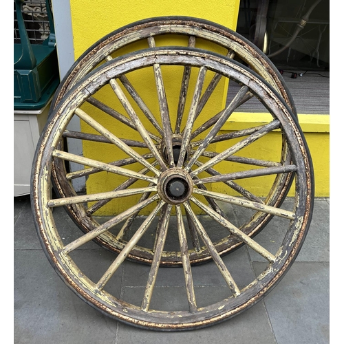 12 - WAGON WHEELS, a pair, wooden spokes with iron and rim in distressed yellow rubber painted finish, 11... 