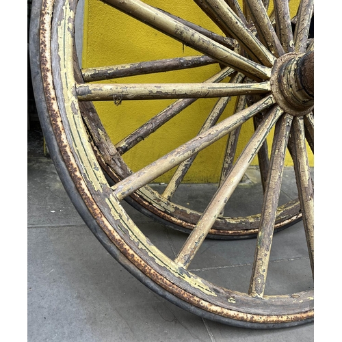 12 - WAGON WHEELS, a pair, wooden spokes with iron and rim in distressed yellow rubber painted finish, 11... 