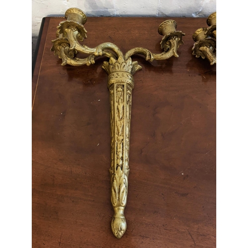 27 - BRASS WALL SCONCES, a pair, each with three branch, 16cm H x 32cm, and another pair gilt, each 47cm ... 