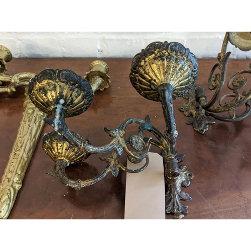 27 - BRASS WALL SCONCES, a pair, each with three branch, 16cm H x 32cm, and another pair gilt, each 47cm ... 