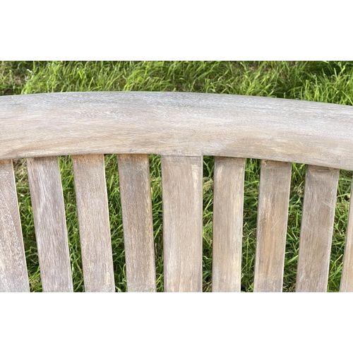 147 - BANANA GARDEN BENCH, weathered teak with curved back and slatted construction, 150cm W.