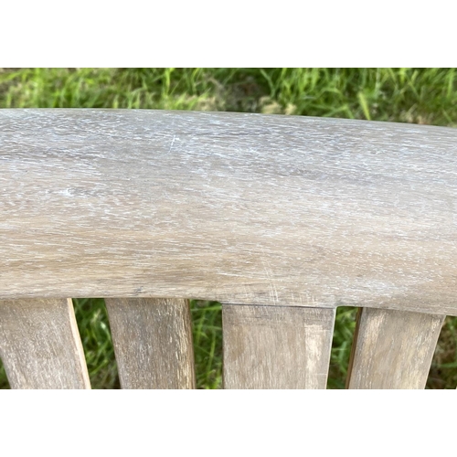 147 - BANANA GARDEN BENCH, weathered teak with curved back and slatted construction, 150cm W.