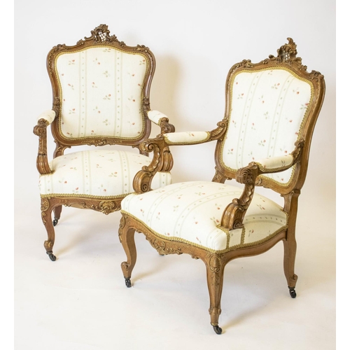 184 - FAUTEUILS, 105cm H x 64cm W, a pair, late 19th century French walnut and gilt heightened in cream fl... 