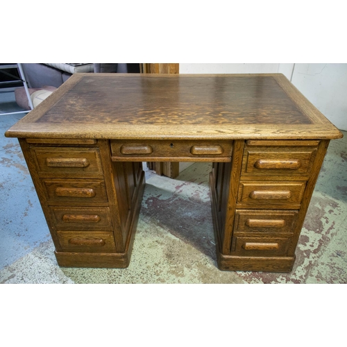 258 - DESK, 77cm H x 122cm W x 80cm D, circa 1925 oak with two slides and eight drawers.