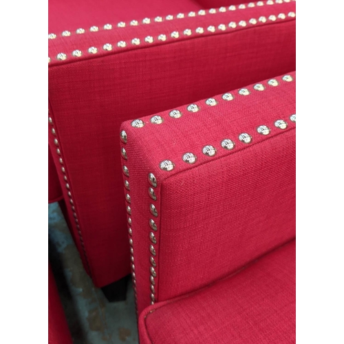 347 - ARMCHAIRS, a pair, each 75cm W x 91cm, red fabric upholstered with studded detail and footstool set.... 