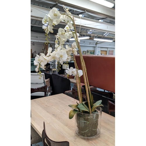 391 - FAUX ORCHID DISPLAY, 135cm H, in a glass bowl.