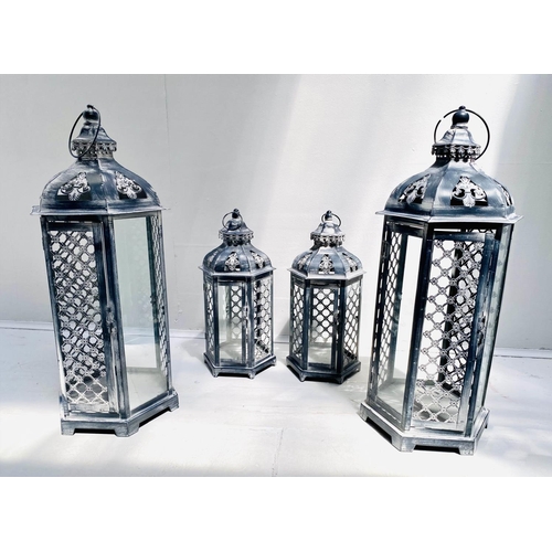 400 - STORM LANTERNS, two graduated pairs, largest measuring 63cm high, 26cm diameter, painted metal. (4)