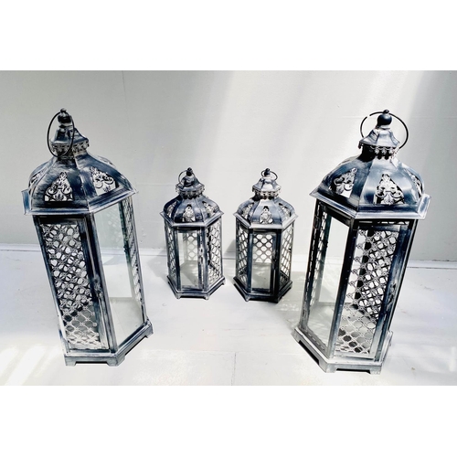 400 - STORM LANTERNS, two graduated pairs, largest measuring 63cm high, 26cm diameter, painted metal. (4)