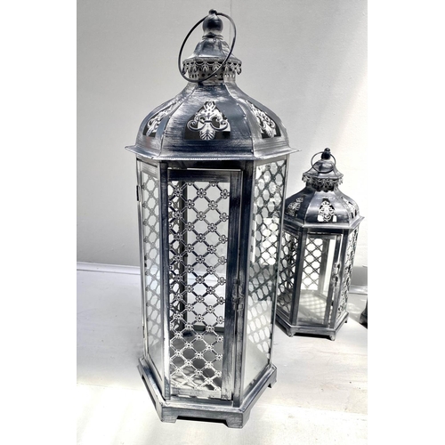 400 - STORM LANTERNS, two graduated pairs, largest measuring 63cm high, 26cm diameter, painted metal. (4)