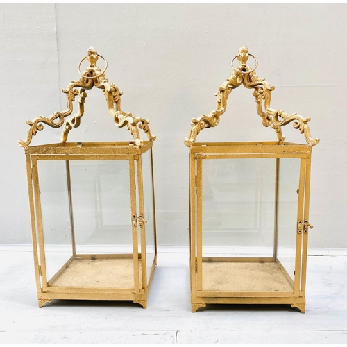 407 - STORM LANTERNS, 60cm high, 27cm wide, a pair, square sectioned, gilt metal frames glazed sides. (2)