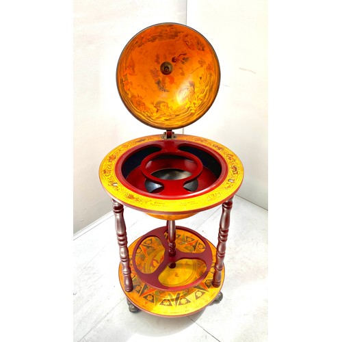 411 - TERRESTRIAL GLOBE COCKTAIL CABINET, 90cm high, 50cm diameter, raised on castors.