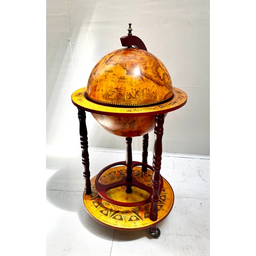 411 - TERRESTRIAL GLOBE COCKTAIL CABINET, 90cm high, 50cm diameter, raised on castors.