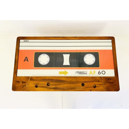 414 - LOW TABLE, 40cm high x 110cm wide x 60cm deep, cassette tape design, with storage to one side.