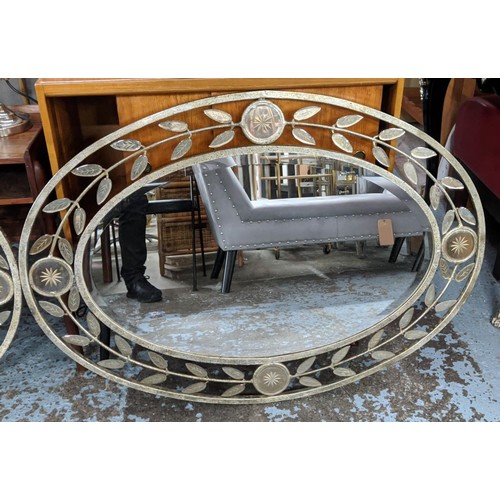 427 - OVAL MIRRORS, a pair, each 75cm W x 107cm H, with distressed metal frames and leaf motif border. (2)