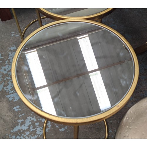 510 - SIDE TABLES, a set of three, largest 43cm x 63cm H, mirrored tops on gilt metal bases. (3)