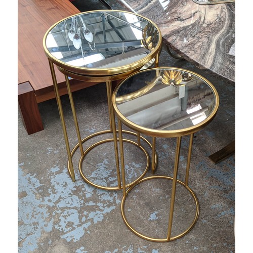 510 - SIDE TABLES, a set of three, largest 43cm x 63cm H, mirrored tops on gilt metal bases. (3)