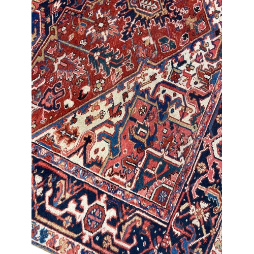 128 - ANTIQUE PERSIAN HERIZ CARPET, 350cm x 255cm.