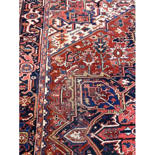 128 - ANTIQUE PERSIAN HERIZ CARPET, 350cm x 255cm.