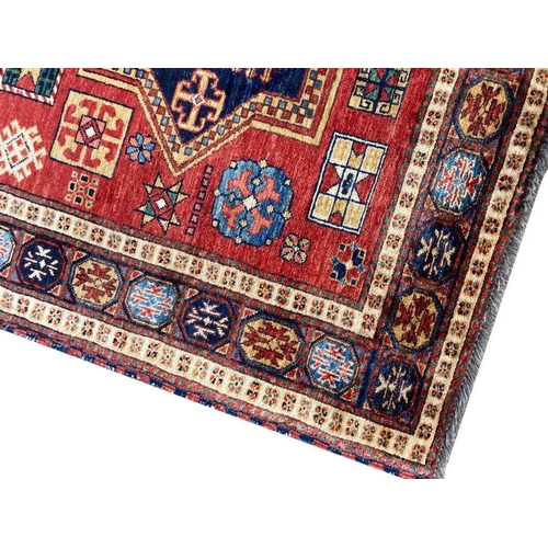 135 - LESGHI KAZAK RUG, 220cm x 140cm.