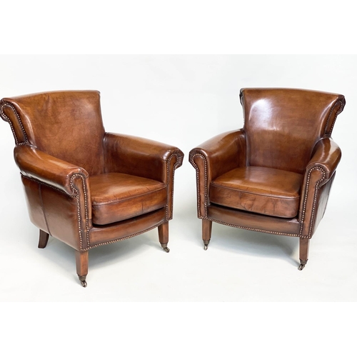 189 - ARMCHAIRS, a pair, club style brass studded tan leather with scroll arms and back and tapering suppo... 