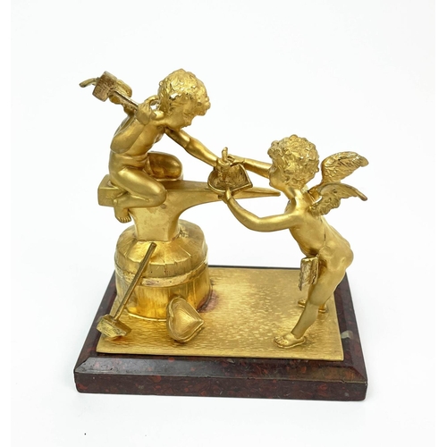 19 - CUPID ORMOLU ORNAMENTS, five three with anvils constructing hearts and rings, one with a heart held ... 