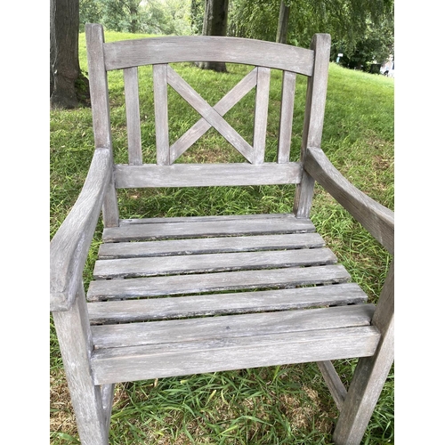 192 - GARDEN ARMCHAIRS, a pair, weathered teak and slatted with lattice backs together with a table, chair... 