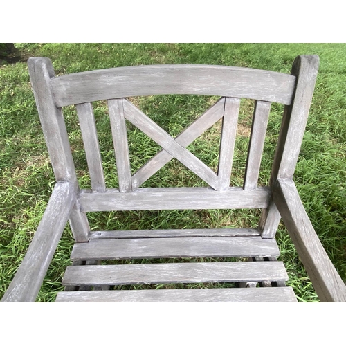 192 - GARDEN ARMCHAIRS, a pair, weathered teak and slatted with lattice backs together with a table, chair... 