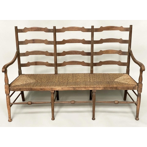 241 - HALL SEAT, early 20th century English oak with raised ladder back and rush seat, 157cm W.