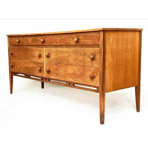 375 - LOW CHEST, mid 20th century teak with seven drawers in the manner of Heals, 148cm x 69cm H x 46cm.