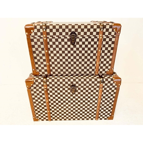 542 - TRUNKS, a graduated pair, largest measuring 42cm H x 72cm W x 42cm D, damier style fabric upholstere... 