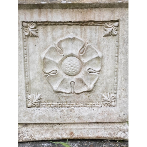 553 - PLANTERS, a pair, weathered composite stone, each square with rosette panelled side, 40cm x 40cm x 4... 